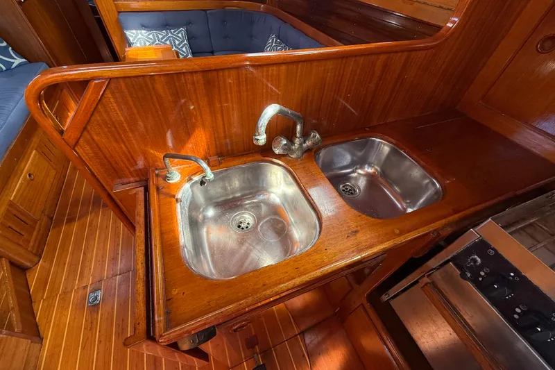 Slide: The Image of Wooden interior of 1986 Vindo 45 yacht with dual stainless steel sinks. - 27
