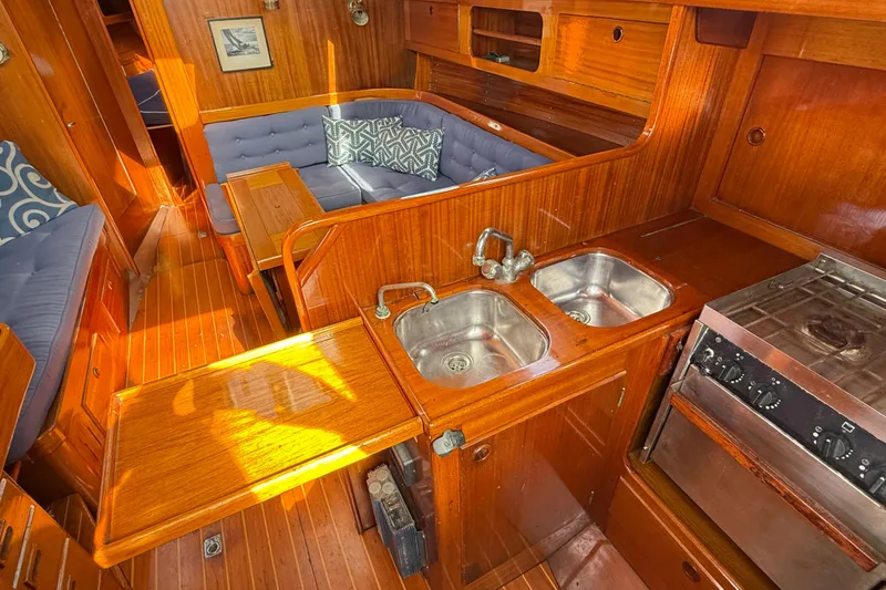Slide: The Image of Interior of 1986 Vindo 45 yacht with wooden cabinetry and cozy seating area. - 28
