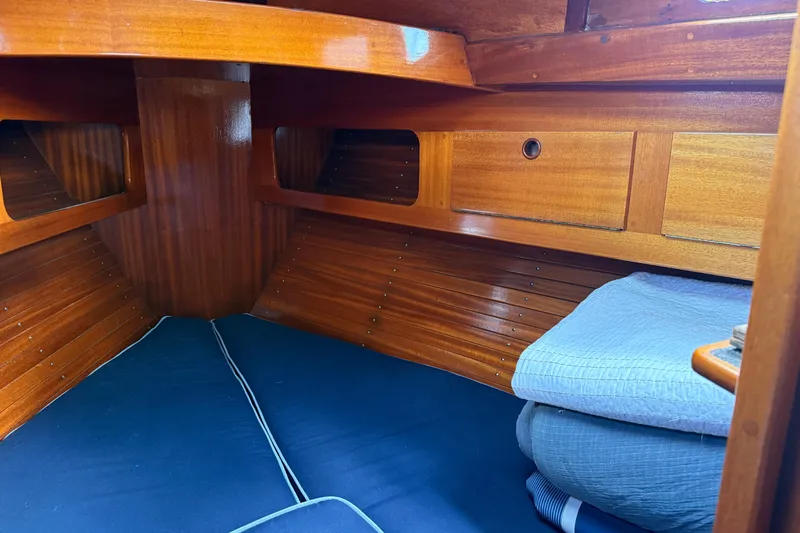 Slide: The Image of Cozy wooden cabin interior of 1986 Vindo 45 sailboat with blue bedding. - 39