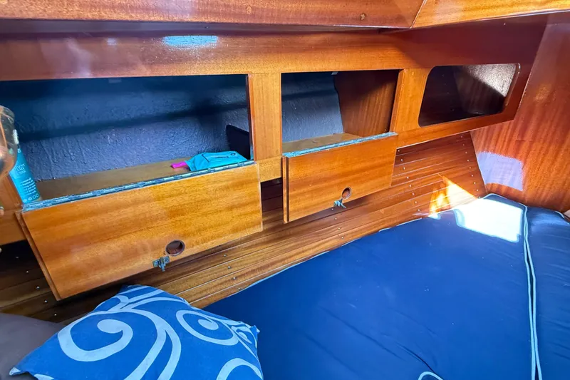 Slide: The Image of Interior of 1986 Vindo 45 sailboat with wooden cabinets and blue bedding. - 40