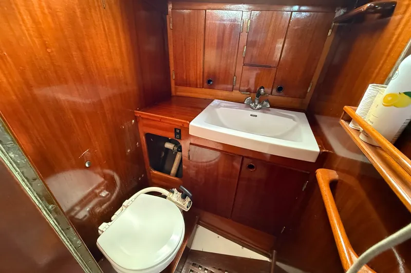 Slide: The Image of Wooden interior of 1986 Vindo 45 yacht bathroom with sink and toilet. - 42
