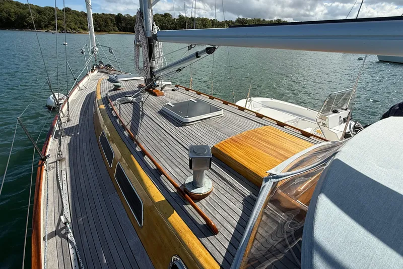 Slide: The Image of Sailboat deck of 1986 Vindo 45, featuring wooden details and scenic water view. - 47