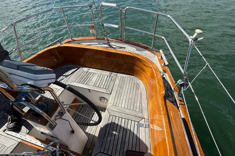 Slide: The Image of Cockpit of 1986 Vindo 45 sailboat with wooden trim and steering wheel. - 49
