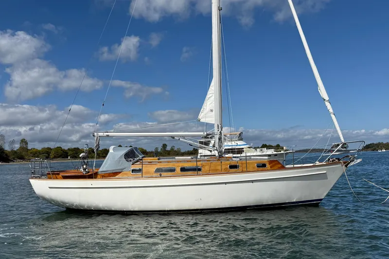 Slide: The Image of Sailing yacht Vindo 45, 1986 model, on calm waters under a clear blue sky. - 6