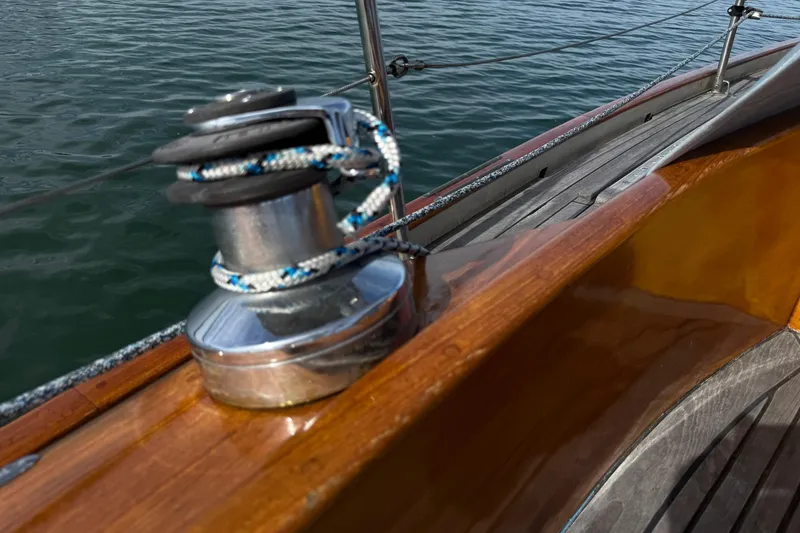 Slide: The Image of Polished winch on 1986 Vindo 45 sailboat with wooden deck and water background. - 61