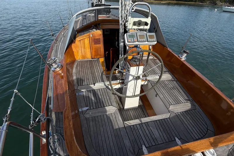 Slide: The Image of 1986 Vindo 45 sailboat cockpit with wooden deck and steering wheel. - 63