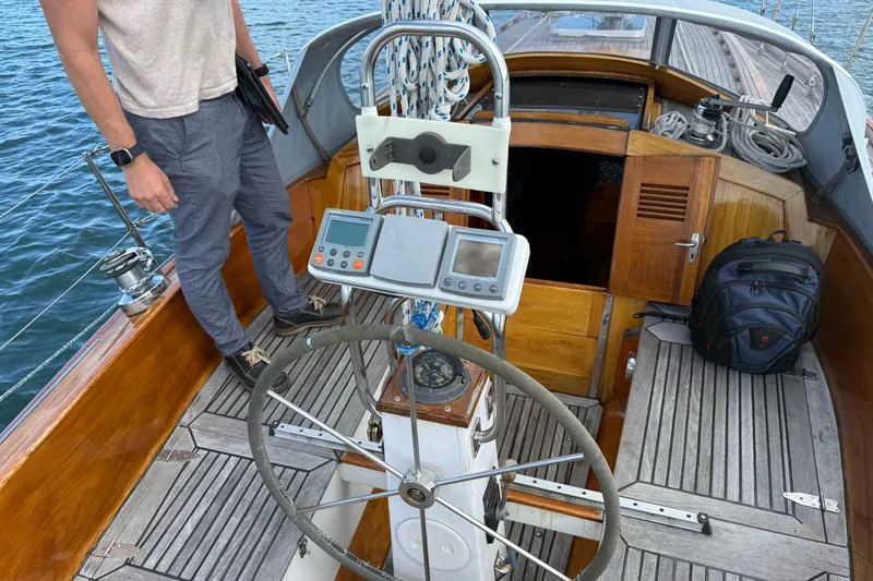 Slide: The Image of Cockpit of 1986 Vindo 45 sailboat with steering wheel and navigation equipment. - 64