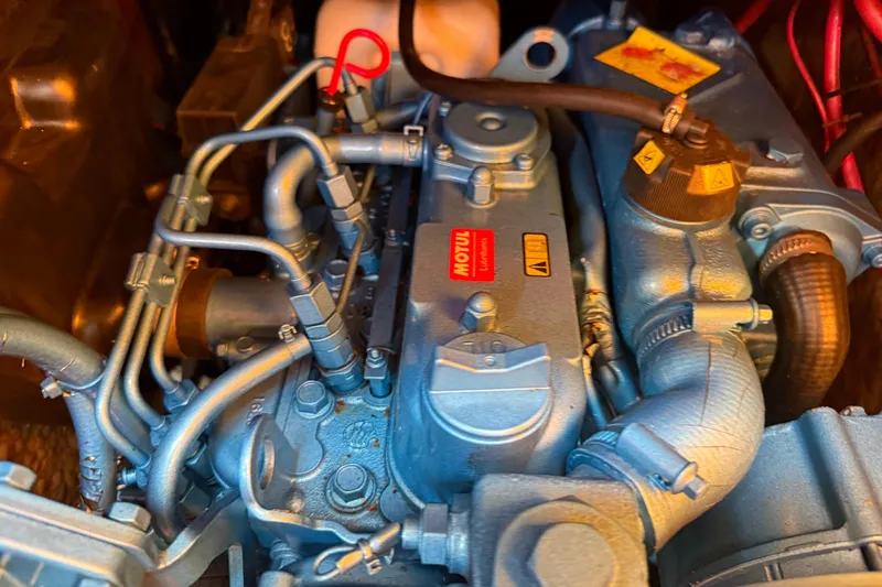 Slide: The Image of Engine of a 1986 Vindo 45 boat, featuring intricate piping and Motul branding. - 73