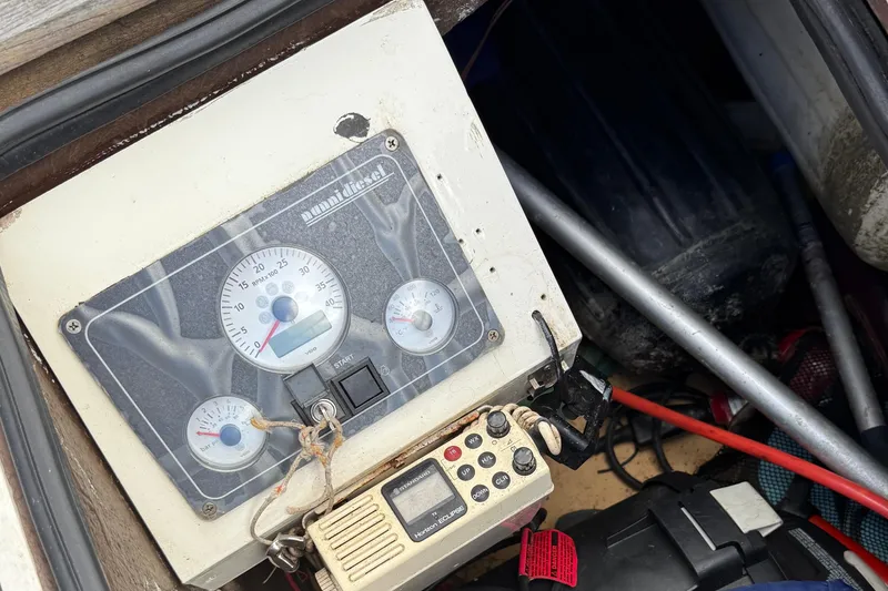 Slide: The Image of Control panel of a 1986 Vindo 45 boat with gauges and radio equipment. - 74