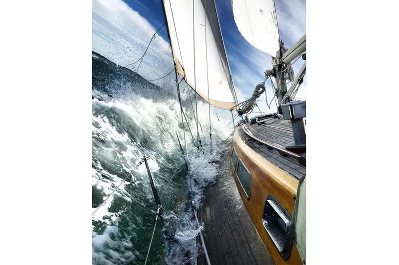 Slide: The Image of Sailing yacht Vindo 45 from 1986 navigating rough seas with white sails. - 79