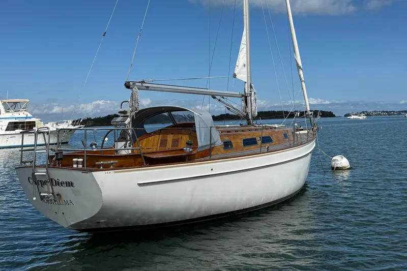 Slide: The Image of Sailboat "Carpe Diem," Vindo 45, 1986 model, anchored in a serene bay. - 8