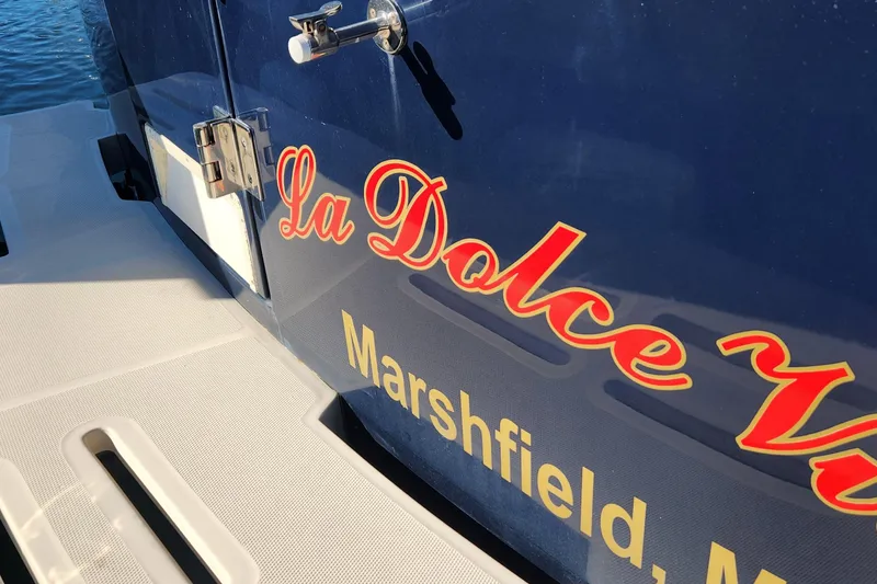 Slide: The Image of 2003 Mainship Pilot 30-II boat with "La Dolce Vita" name, docked in Marshfield. - 12