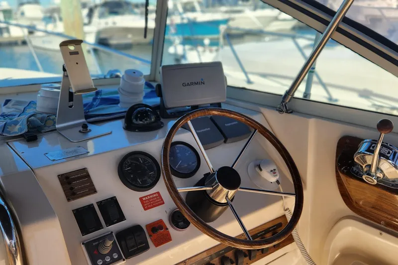 Slide: The Image of 2003 Mainship Pilot 30-II helm with Garmin GPS, wooden steering wheel, and control panel. - 15