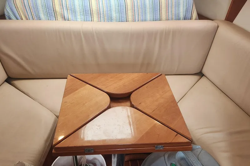 Slide: The Image of Interior of 2003 Mainship Pilot 30-II with wooden table and beige seating. - 21