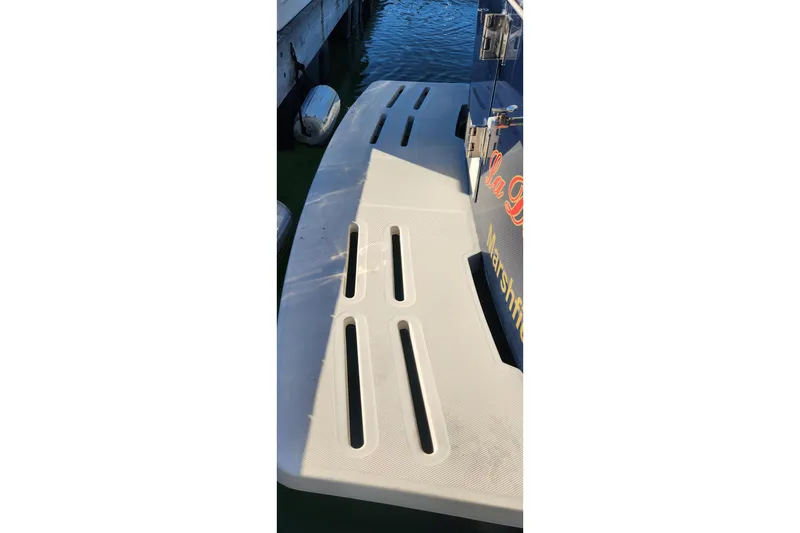 Slide: The Image of 2003 Mainship Pilot 30-II swim platform with dockside view. - 33