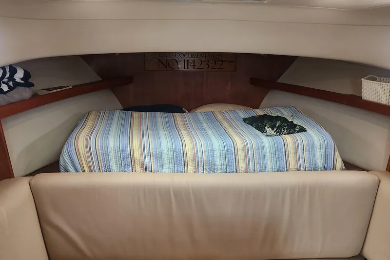 Slide: The Image of Cozy cabin interior of 2003 Mainship Pilot 30-II with striped bedding. - 9