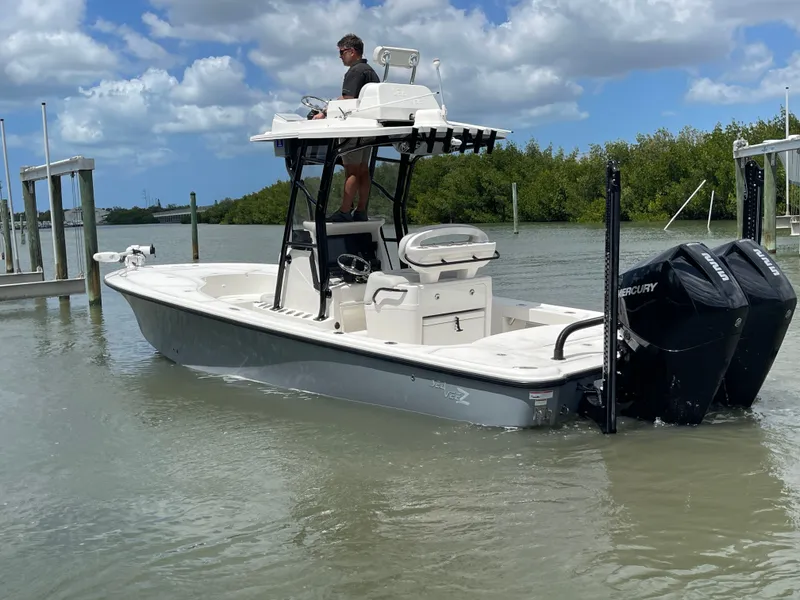Slide: The Image of 2023 SeaVee 270 Z boat on calm water with blue sky. - 14
