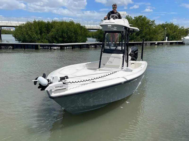 Slide: The Image of 2023 SeaVee 270 Z boat on calm water with captain. - 16