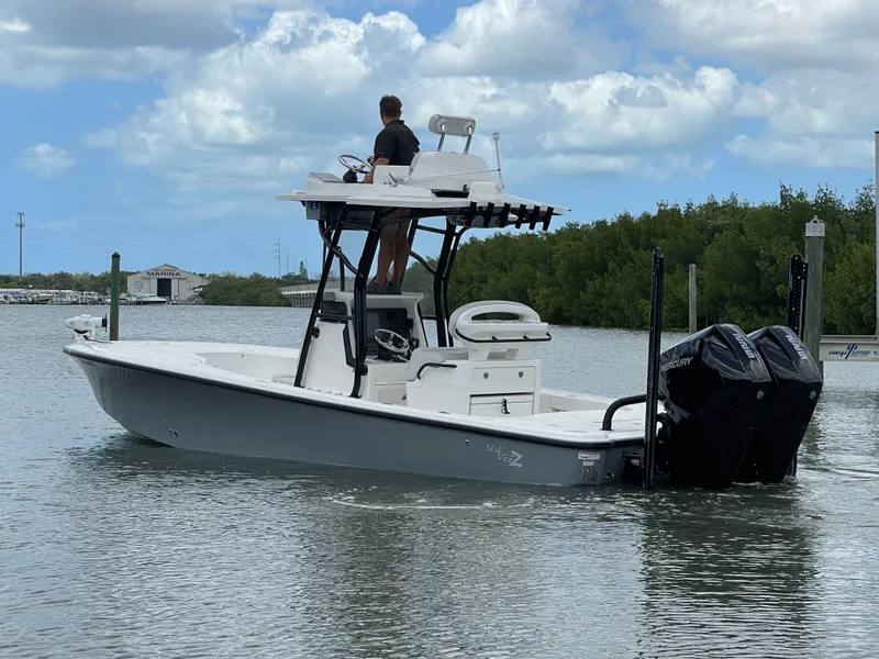 Slide: The Image of 2023 SeaVee 270 Z boat on calm water with dual outboard engines. - 2