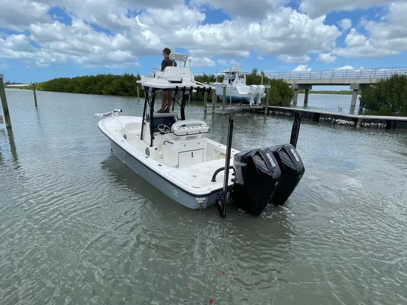 Slide: The Image of 2023 SeaVee 270 Z boat on calm water with dual outboard engines. - 22