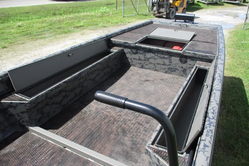 Slide: The Image of 2026 Gator Tail 1860 Extreme boat interior with open storage compartments and textured flooring. - 6