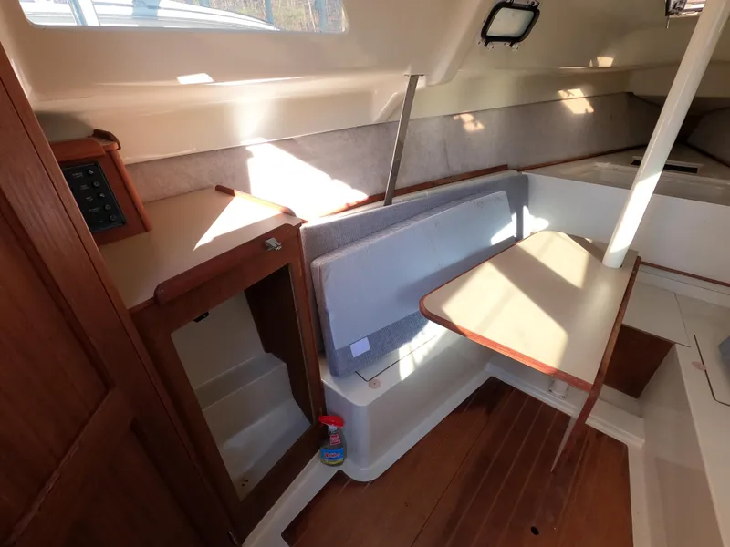 Slide: The Image of Interior of a 1992 Hunter 27 yacht with table and seating area. - 11