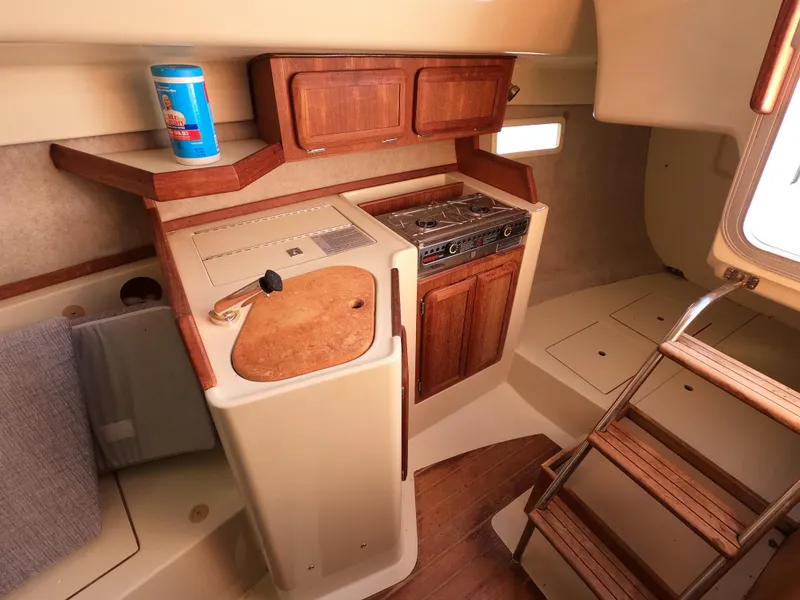 Slide: The Image of Interior of a 1992 Hunter 27 yacht with kitchen and wood details. - 13