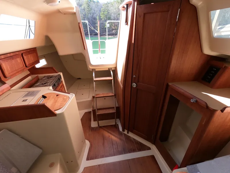 Slide: The Image of Interior of a 1992 Hunter 27 yacht with wooden furnishings. - 14