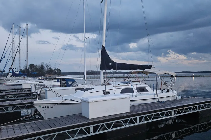 Slide: The Image of Sailboat docked at marina, Hunter 27 model, 1992, under cloudy sky. - 2