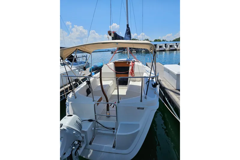 Slide: The Image of 1992 Hunter 27 sailboat docked at marina under clear blue sky. - 20