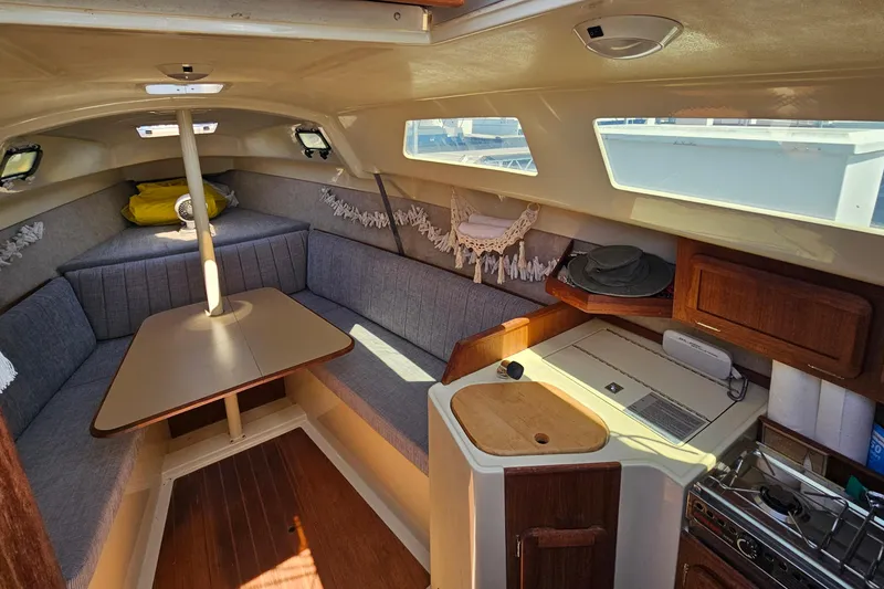 Slide: The Image of Cozy interior of a 1992 Hunter 27 sailboat with seating and kitchenette. - 7