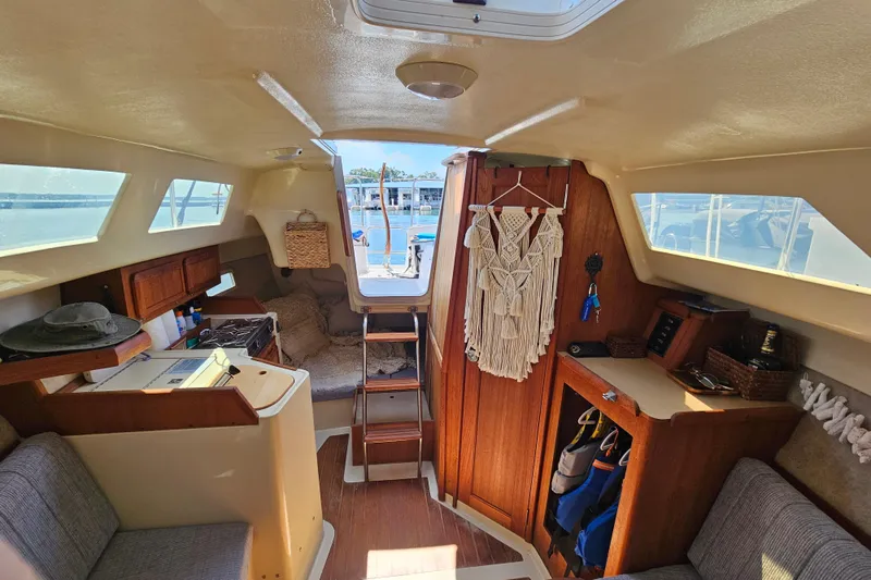 Slide: The Image of Interior of a 1992 Hunter 27 sailboat with cozy seating and nautical decor. - 8