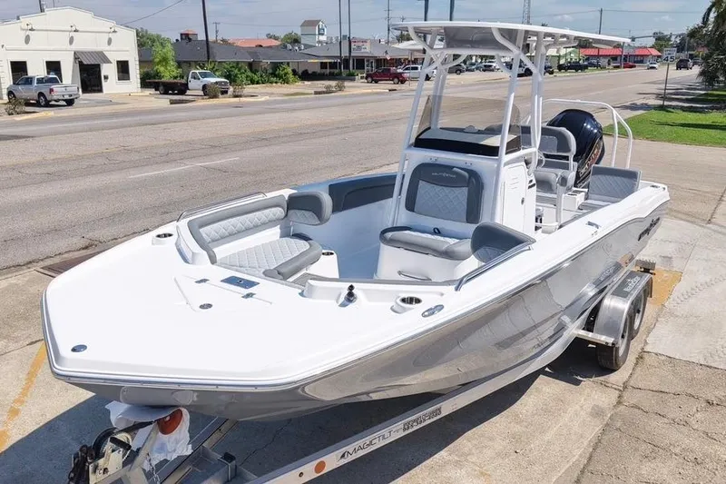 Slide: The Image of 2026 NauticStar 231 Hybrid boat on trailer, parked on urban street. - 5