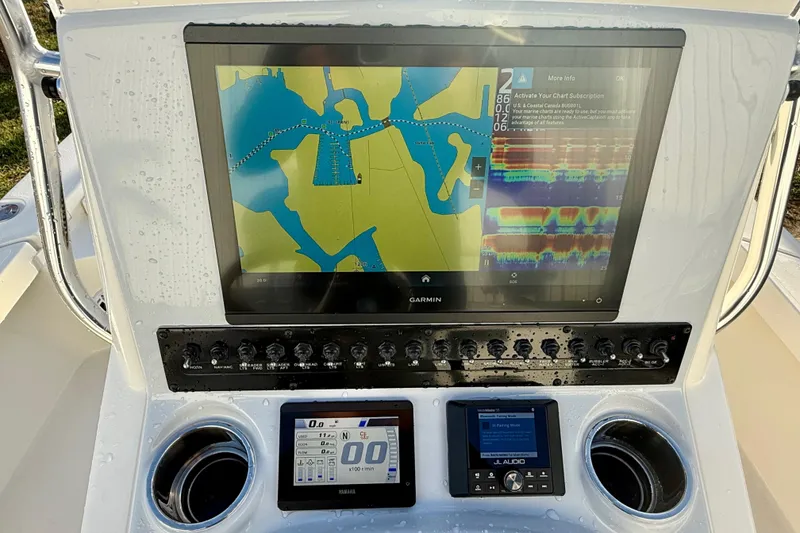 Slide: The Image of Control panel of 2025 Pathfinder 2300 HPS boat with Garmin navigation display. - 10