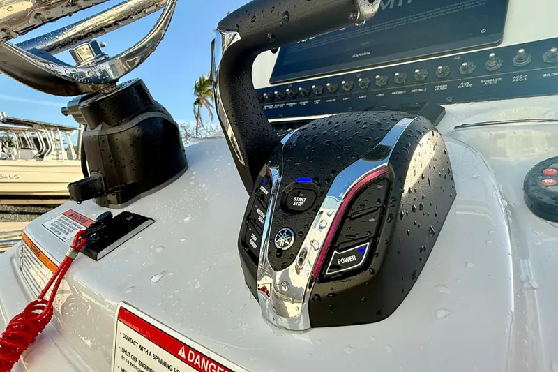 Slide: The Image of 2025 Pathfinder 2300 HPS boat console with wet throttle controls and steering wheel. - 12