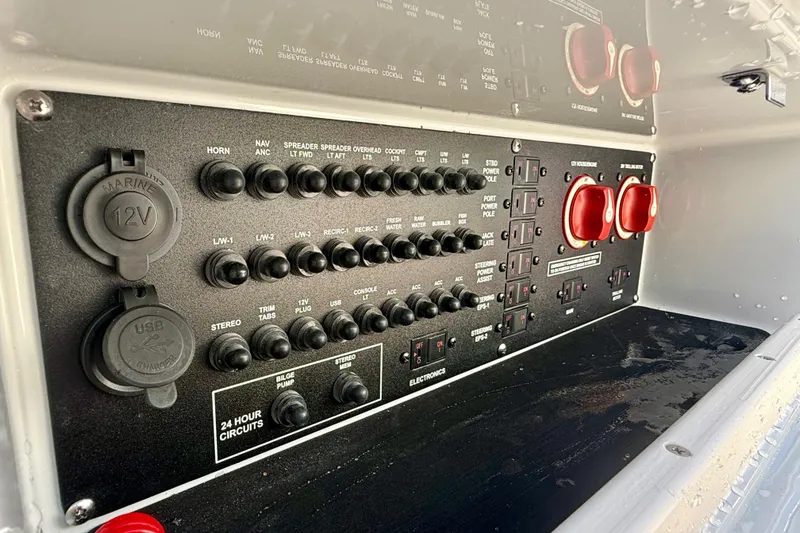 Slide: The Image of Control panel of 2025 Pathfinder 2300 HPS boat with switches and USB ports. - 14