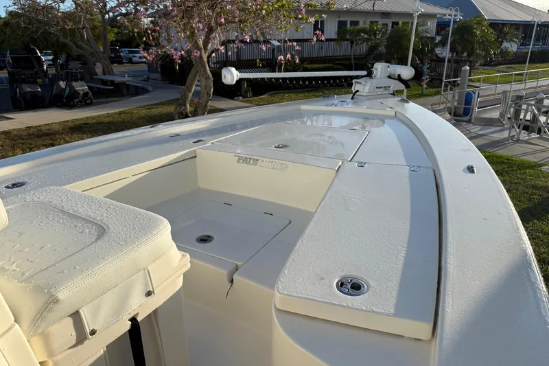 Slide: The Image of 2025 Pathfinder 2300 HPS boat deck with seating and storage compartments. - 18