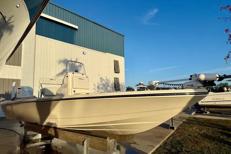Slide: The Image of 2025 Pathfinder 2300 HPS boat displayed outdoors, under clear blue sky. - 2