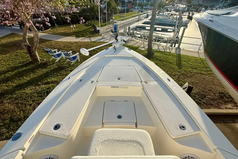 Slide: The Image of 2025 Pathfinder 2300 HPS boat docked, showcasing spacious deck and sleek design. - 20