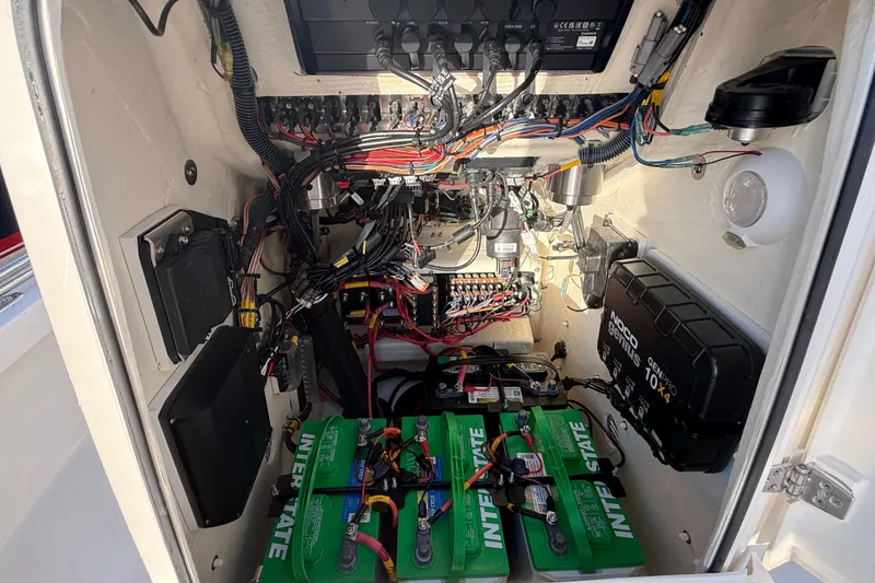 Slide: The Image of Electrical system inside 2025 Pathfinder 2300 HPS boat, featuring batteries and wiring components. - 22