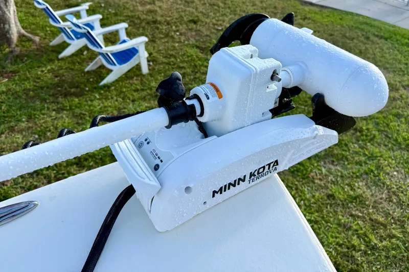 Slide: The Image of Minn Kota Terrova motor on 2025 Pathfinder 2300 HPS boat, with lawn chairs in background. - 24