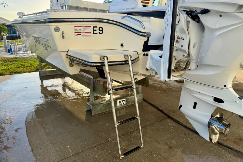 Slide: The Image of 2025 Pathfinder 2300 HPS boat on trailer with ladder and outboard motor. - 3