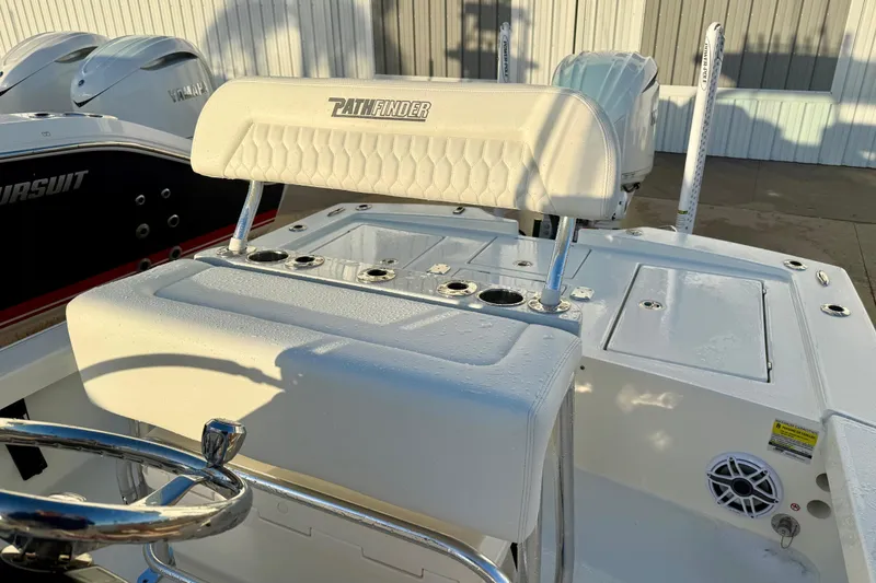 Slide: The Image of 2025 Pathfinder 2300 HPS boat interior with steering wheel and seating, showcasing modern design. - 7