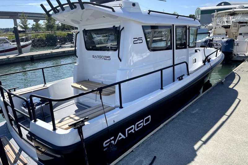 Slide: The Image of 2022 Sargo 25 boat docked at marina, showcasing sleek design and modern features. - 1