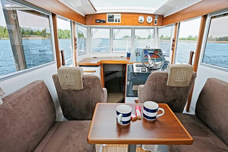 Slide: The Image of Interior of a 2022 Sargo 25 boat with table and mugs. - 10