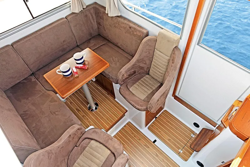 Slide: The Image of Interior of 2022 Sargo 25 yacht with cozy seating and wooden table. - 7
