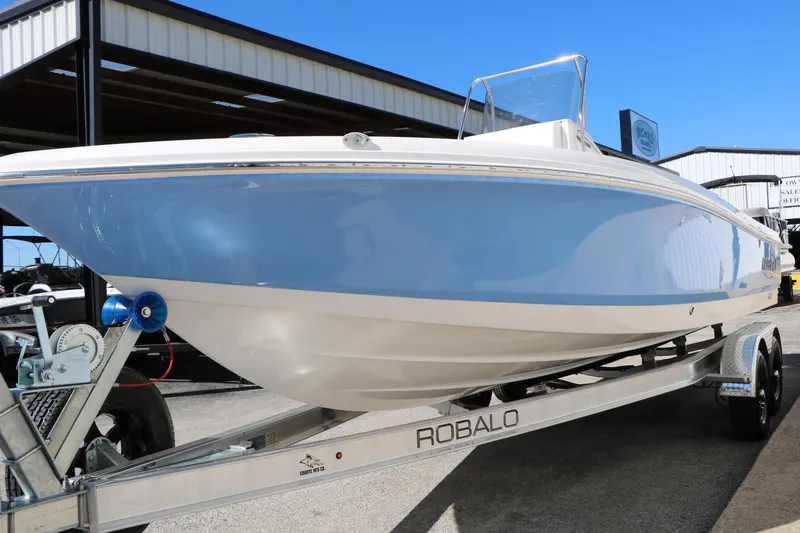 Slide: The Image of 2026 Robalo 226 Cayman boat on trailer, blue and white hull, outdoor display. - 12