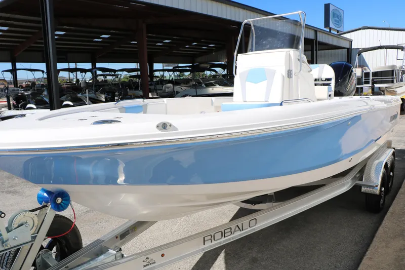 Slide: The Image of 2026 Robalo 226 Cayman boat on trailer, displayed outdoors. - 13