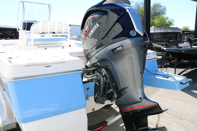Slide: The Image of 2026 Robalo 226 Cayman boat with Yamaha outboard motor, docked outdoors. - 15
