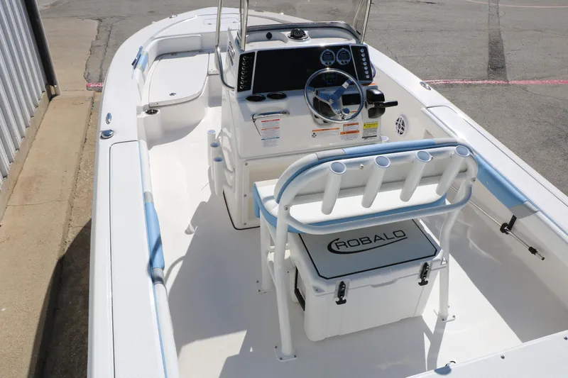Slide: The Image of 2026 Robalo 226 Cayman boat interior with steering console and seating. - 16